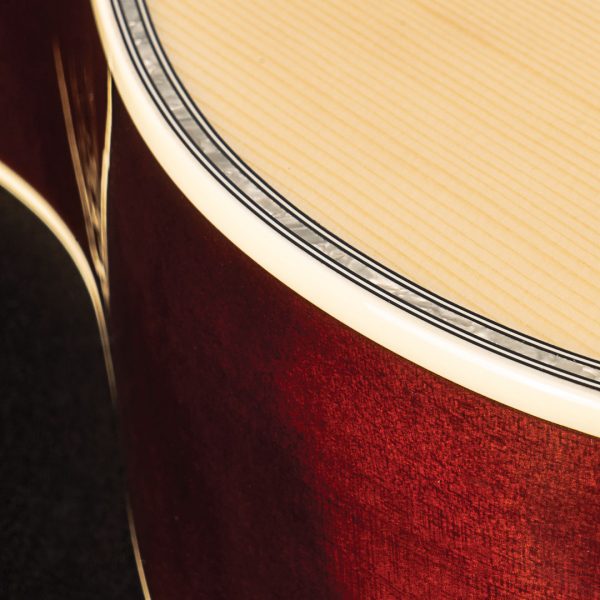 closeup of dark and light wood on edge of Oscar Schmidt acoustic guitar