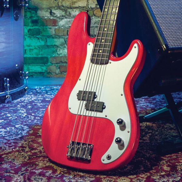 red electric bass leaned against amp